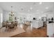 Spacious living area has an open floor plan with hardwood floors and seamless flow between dining, kitchen, and living spaces at 1850 Treasure Cv, Celebration, FL 34747