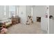 Cozy loft area with comfortable seating, shelving units, and a bright window for natural light at 1850 Treasure Cv, Celebration, FL 34747