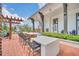 Outdoor kitchen area with bar seating, grills, and prep areas for residents to enjoy open-air cooking at 1850 Treasure Cv, Celebration, FL 34747