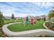 Community playground featuring modern play equipment and artificial turf, creating a safe and fun environment at 1850 Treasure Cv, Celebration, FL 34747