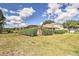 Expansive backyard with a screened-in pool and lush landscaping, offering a serene and private outdoor retreat at 214 Tupelo Cir, Davenport, FL 33897