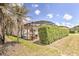 Home with a screened-in patio and lush landscaping, providing a tranquil outdoor living space at 214 Tupelo Cir, Davenport, FL 33897
