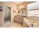 Well-lit bathroom featuring tiled floor and a glass-enclosed shower at 214 Tupelo Cir, Davenport, FL 33897
