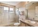Well-lit bathroom features a glass-enclosed shower, modern fixtures, and a functional vanity at 214 Tupelo Cir, Davenport, FL 33897