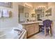 Bathroom with a corner tub, countertop vanity and large mirrors at 214 Tupelo Cir, Davenport, FL 33897