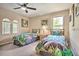 Charming bedroom showcasing two beds, natural light, and tasteful decor for a cozy feel at 214 Tupelo Cir, Davenport, FL 33897