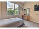 Bright bedroom featuring a large window, a dresser, and serene ambiance for relaxation at 214 Tupelo Cir, Davenport, FL 33897