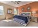 Inviting primary bedroom featuring decorative mirrors, bedside tables, and a spacious closet at 214 Tupelo Cir, Davenport, FL 33897