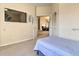 Cozy bedroom offering a tranquil retreat with views, a mounted TV, and easy access to other rooms at 214 Tupelo Cir, Davenport, FL 33897