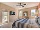 Spacious bedroom with a ceiling fan and a sliding glass door to an outdoor patio at 214 Tupelo Cir, Davenport, FL 33897