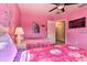 Charming themed pink bedroom featuring two beds, a ceiling fan, and ample space for relaxation at 214 Tupelo Cir, Davenport, FL 33897