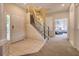 Inviting foyer with tiled floors, staircase, and view to a bedroom through an archway at 214 Tupelo Cir, Davenport, FL 33897