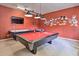 Spacious game room with pool table, TV, and Disney themed wall art at 214 Tupelo Cir, Davenport, FL 33897