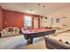 Recreational room featuring a pool table and foosball table, with a sofa and neutral carpeting at 214 Tupelo Cir, Davenport, FL 33897