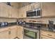 Well-lit kitchen features stainless steel appliances, granite countertops, and ample cabinet space at 214 Tupelo Cir, Davenport, FL 33897