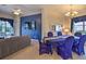 Bright living room with a blue accent wall, a large TV, and access to the lanai at 214 Tupelo Cir, Davenport, FL 33897