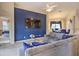 Open-concept living room featuring an accent wall, comfortable seating, and access to dining area at 214 Tupelo Cir, Davenport, FL 33897