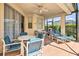 Covered patio with comfortable seating, offering an ideal spot for outdoor dining and relaxation at 214 Tupelo Cir, Davenport, FL 33897