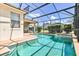 Backyard with a screened-in pool and patio, providing a relaxing and private outdoor living space at 214 Tupelo Cir, Davenport, FL 33897
