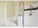 A stylish bathroom featuring a tub and a tiled shower with glass doors at 223 Cadiz Loop, Davenport, FL 33837
