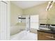 Bright bathroom with a shower, large tub, double sinks, and tiled floors, offering a relaxing and stylish space at 223 Cadiz Loop, Davenport, FL 33837