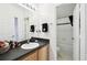 Bathroom features a sink, a mirror, decor, and a shower and toilet combo at 223 Cadiz Loop, Davenport, FL 33837
