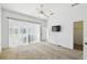 Bright bedroom featuring a ceiling fan, large windows, and a TV, offering a comfortable and modern living space at 223 Cadiz Loop, Davenport, FL 33837