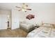 Bright bedroom featuring two twin beds, a ceiling fan, and a doorway at 223 Cadiz Loop, Davenport, FL 33837