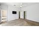 Minimalist bedroom with neutral carpet, ceiling fan, closet, and adjacent access to bathroom at 223 Cadiz Loop, Davenport, FL 33837