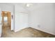 Carpeted bedroom features a closet and a ceiling fan with a light fixture at 223 Cadiz Loop, Davenport, FL 33837