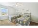 Bright bedroom has two twin beds, a ceiling fan, and a window overlooking the outdoors at 223 Cadiz Loop, Davenport, FL 33837