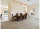 A well-lit dining room featuring a wooden dining table and view of backyard through the sliding glass doors at 223 Cadiz Loop, Davenport, FL 33837