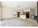 Open-concept living room with light wood cabinets in kitchen, ceiling fan, and sliding glass doors at 223 Cadiz Loop, Davenport, FL 33837