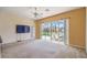 Bright living room with sliding glass doors leading to a screened-in patio and a pool view at 223 Cadiz Loop, Davenport, FL 33837