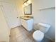 Bathroom featuring a granite vanity top, decorative mirror, and tiled floors at 2330 Prime Cir # A, Kissimmee, FL 34746