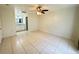 Bedroom with en suite bathroom, ceiling fan, and tiled flooring at 2330 Prime Cir # A, Kissimmee, FL 34746