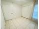 Tile-floored bedroom featuring a double door closet and a window with blinds at 2330 Prime Cir # A, Kissimmee, FL 34746
