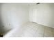 Bright bedroom with tile flooring and a closet provides ample storage space at 2330 Prime Cir # A, Kissimmee, FL 34746