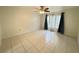 Neutral bedroom with tile flooring, large windows, and a ceiling fan at 2330 Prime Cir # A, Kissimmee, FL 34746