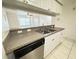 Eat-in kitchen with double sinks, breakfast bar, white cabinets, and a dishwasher at 2330 Prime Cir # A, Kissimmee, FL 34746