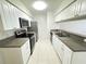 Bright kitchen with stainless steel appliances, double sinks, and white cabinets at 2330 Prime Cir # A, Kissimmee, FL 34746