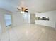 Open-concept living room with tile flooring and a view into the kitchen at 2330 Prime Cir # A, Kissimmee, FL 34746