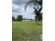 Lush backyard overlooking a tranquil pond with mature trees at 2385 Andrews Valley Dr, Kissimmee, FL 34758