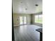 Bright room featuring a patio door, a pool view, and sleek gray floors at 2385 Andrews Valley Dr, Kissimmee, FL 34758