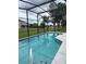 Relaxing screened-in pool with tranquil reflections and surrounding greenery, enhancing the outdoor oasis experience at 2385 Andrews Valley Dr, Kissimmee, FL 34758
