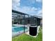 View of sparkling pool within screened lanai and glimpse of home exterior, creating a serene outdoor living space at 2385 Andrews Valley Dr, Kissimmee, FL 34758