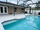 Inviting screened pool with a pristine deck and blue-tiled trim, perfect for relaxation and outdoor enjoyment at 2385 Andrews Valley Dr, Kissimmee, FL 34758