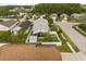 Aerial view of backyard, white fenced yard, mature landscaping and enclosed lanai at 2411 Parsons Pond Cir, Kissimmee, FL 34743