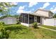 Backyard view of the home's enclosed lanai and a shed for extra storage at 2411 Parsons Pond Cir, Kissimmee, FL 34743