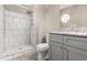 A bathroom with a tiled shower and granite vanity at 2411 Parsons Pond Cir, Kissimmee, FL 34743
